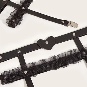 Close-up of black leather heart garter with lace trim and silver metal snap fasteners