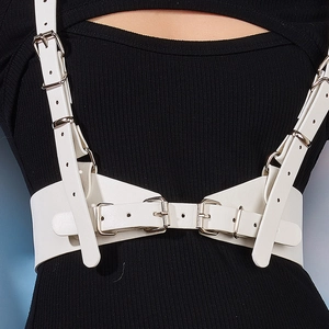 Detail of white PU leather body harness with silver adjustable buckles on black top
