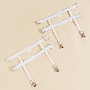 Detail of white lace thigh rings with heart charms and metal clips for stockings