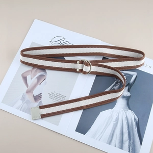 Detail of striped canvas belt with double D-ring buckle and reinforced gray end edge