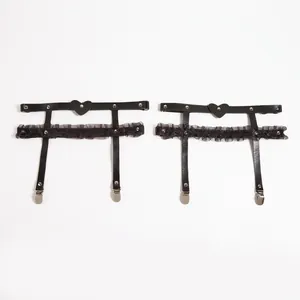 Pair of black lace thigh garters with heart rivets and metal clips in punk style