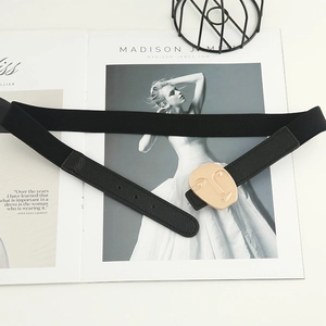 Elastic black waist belt for dresses with an artistic gold abstract face metal buckle