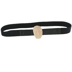 Women's black elastic waist belt featuring a unique gold abstract face buckle accessory