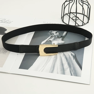 Women's black elastic waist belt with a polished gold U-shaped buckle for dresses
