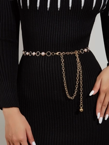 Detail of gold metal waist chain with white pearls and adjustable lobster clasp