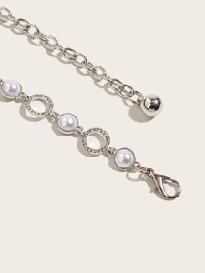 Detail view of silver rhinestone chain belt with pearls and lobster clasp for dresses