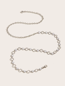 Detail of silver chain belt with white pearls and adjustable lobster clasp for dresses