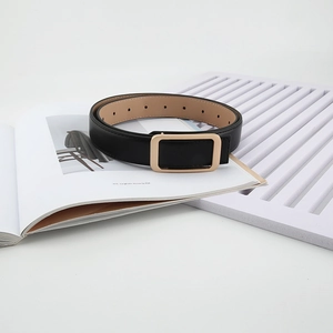 Detailed view of black leather belt with rectangular gold buckle and adjustable holes