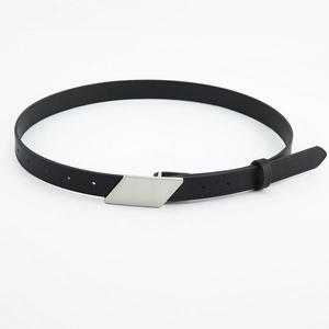 Detail of minimalist black faux leather belt with a silver geometric brushed metal buckle