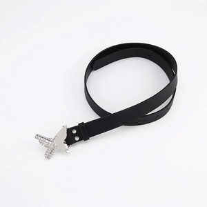 Detailed view of silver butterfly buckle on black matte belt for jeans and dresses