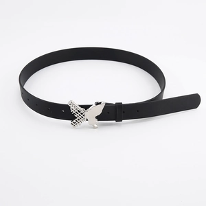 Detail of a thin black belt featuring a silver butterfly buckle with lattice engraving