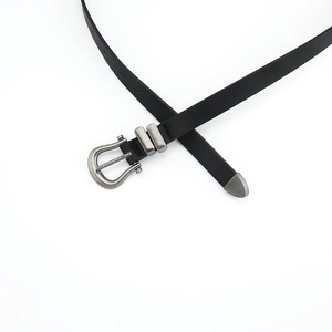Vintage black skinny leather belt with retro silver metal buckle and tip on white background