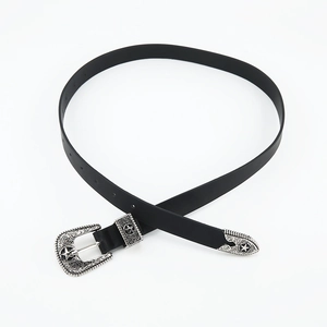 Close-up of vintage black slim belt with carved silver buckle and western star details