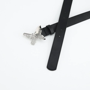 Detail of silver butterfly buckle on black leather belt with hollow grid design