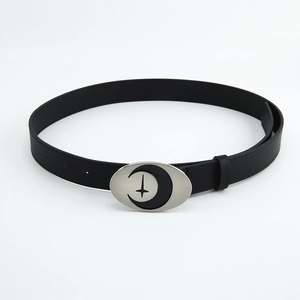 Detail of black leather belt with silver moon and star buckle on white background
