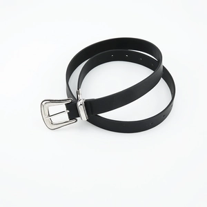 Detail of vintage black slim belt featuring an ornate silver bohemian buckle and textures