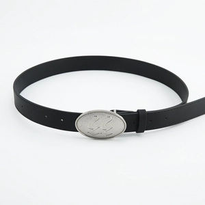 Close-up of black leather belt with silver oval buckle and artistic hollowed S design