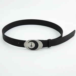 Detail of black leather belt with silver moon and star buckle on white background