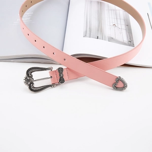 Pink slim leather belt with vintage floral silver buckle and heart metal tip on magazine