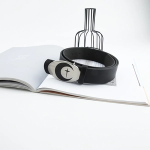 Gothic belt with silver crescent moon and star buckle on a minimalist background