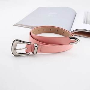 Detail of pink leather belt with vintage silver buckle and engraved metal tip accessory