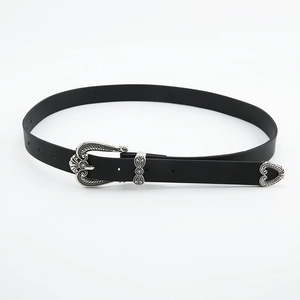 Vintage bohemian style thin black leather belt featuring ornate silver floral engraved buckle