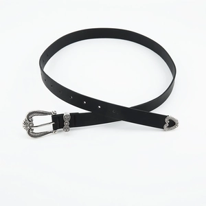 Close-up of vintage women belt with engraved silver buckle and western metal tip detail