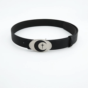 Close-up of silver oval buckle with crescent and cross star pattern on black leather belt