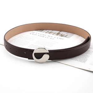 Detailed view of dark brown leather belt with stylish silver hollow round buckle