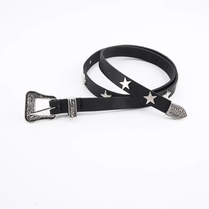 Detail of black leather star belt with vintage silver buckle and metallic studs