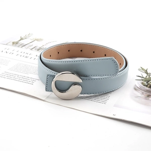 Close-up of light blue leather belt with polished silver circular G-shaped buckle