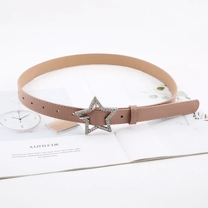 Detail of nude leather belt featuring a large star buckle with glittering rhinestones