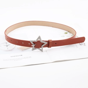 Detail of caramel thin belt with a silver star buckle and sparkling rhinestones