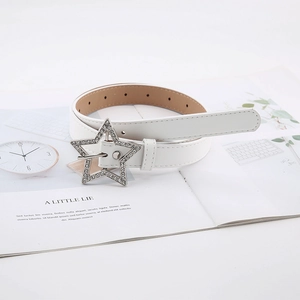 Detail of a thin white leather belt featuring a star-shaped buckle with silver rhinestones