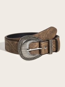 Detail of vintage brown leather belt with floral embossing and carved silver buckle