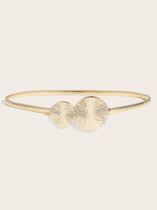 Close-up of golden elastic metal belt featuring elegant double sunburst textured discs