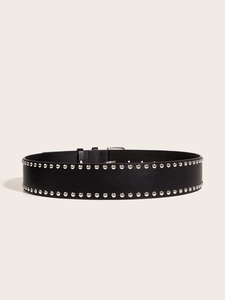 Close-up of black punk style wide belt with double rows of silver metal studs