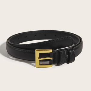 Close-up of black leather belt with golden square buckle and fine stitching details