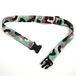 Detail of adjustable camouflage nylon belt featuring a black plastic quick-release buckle