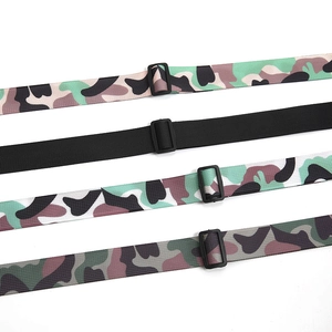 Detail of adjustable camouflage nylon belts for kids with durable black plastic buckles
