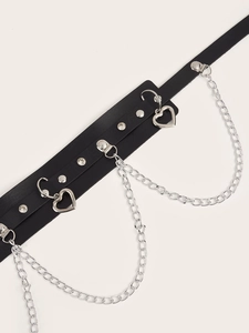 Close-up of punk black leather belt featuring silver chains, rivets and heart pendants