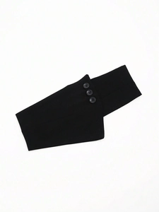 Detail view of the black elastic corset belt fabric with decorative buttons and geometric cut