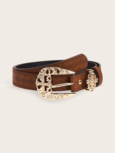 Detail of western retro brown leather belt featuring embossed patterns and carved gold buckle