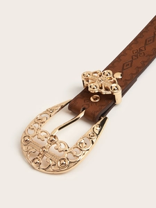 Macro shot of brown embossed leather belt with ornate golden horseshoe metal buckle