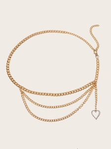 Detail of a gold multi-layer chain belt with a sparkling heart pendant and lobster clasp