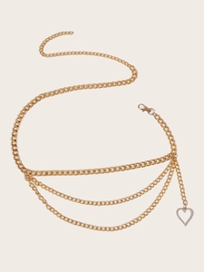 Detail of gold multi-layer waist chain featuring a heart-shaped rhinestone pendant