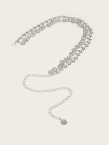 Detail of silver vintage metal waist chain featuring embossed coin charms and lobster clasp
