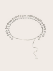Detailed macro view of silver bohemian metal chain belt with coin-shaped pendants