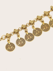 Detailed macro shot of vintage gold coin chain belt featuring intricate embossed patterns