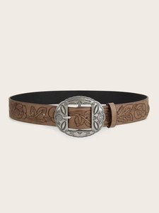 Detail of vintage Y2K brown leather belt with bohemian silver buckle for jeans